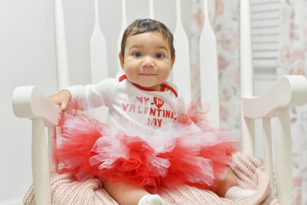 Baby wearing a tutu in a chair